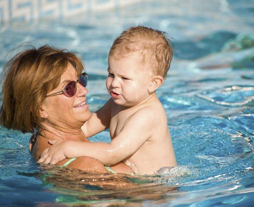 Senior woman and a baby in a pool