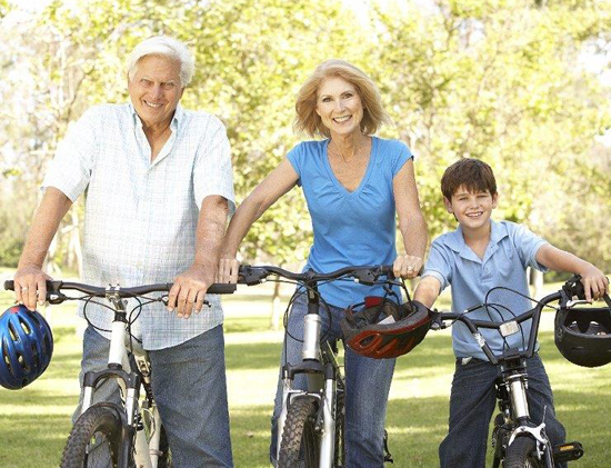 Senior couple and a kid on bikes