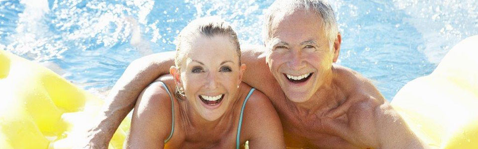 Happy senior couple in a pool